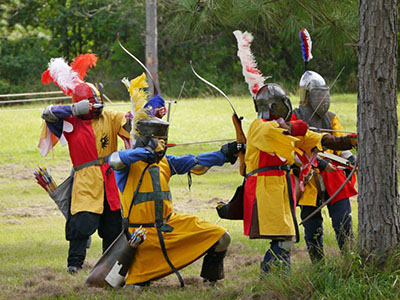 a group of archers wearing medieval clothing